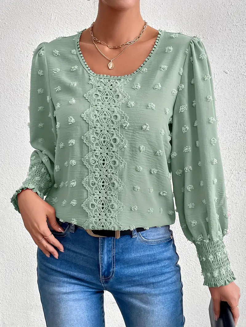 Damblus med schweiziska prickar och charm – Elegant rundhalsad topp med textur och fina polkadetaljer